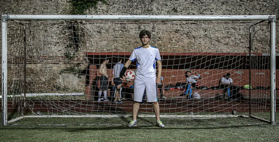 A football player shooting the ball at a goal