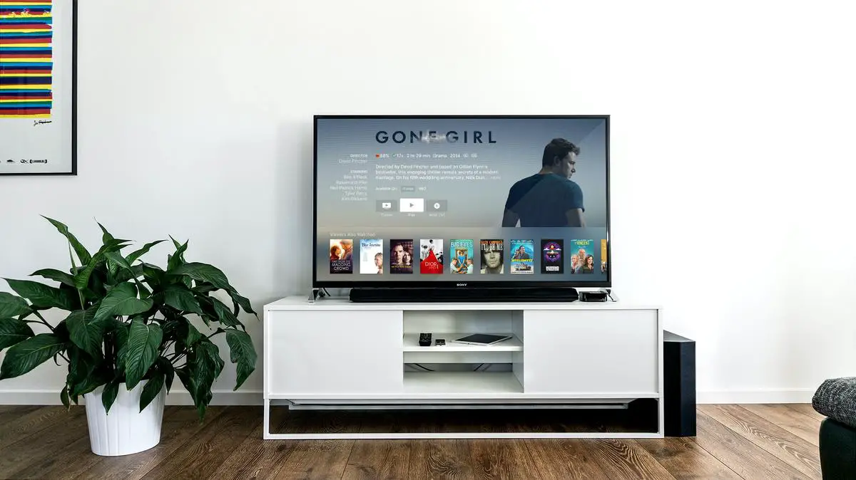 Image of a Super Bowl commercial scene with people sitting on a couch watching a TV