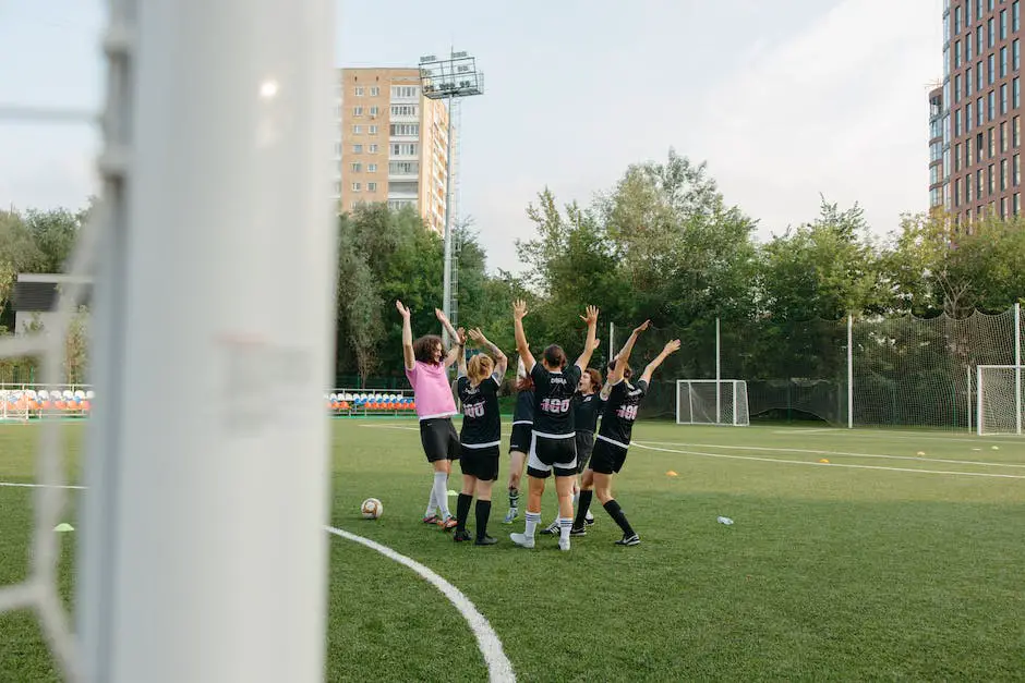 A group of female soccer players celebrating a win on a soccer field